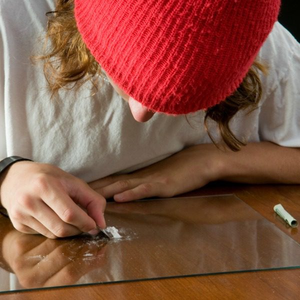 Drug dealer snorting cocaine