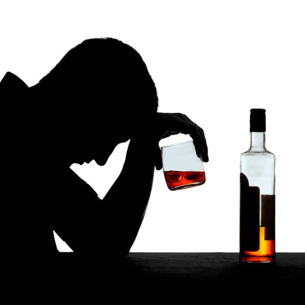 Alcoholic man in silhouette