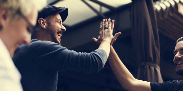 Two men high five