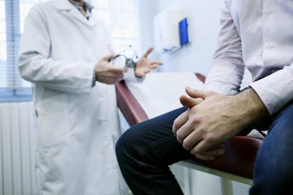 Patient with doctor in exam room