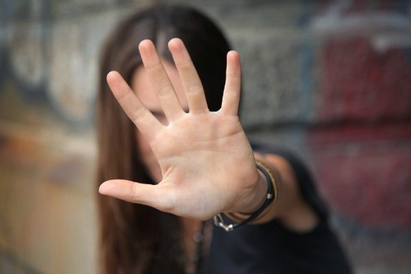 Woman in denial hand up