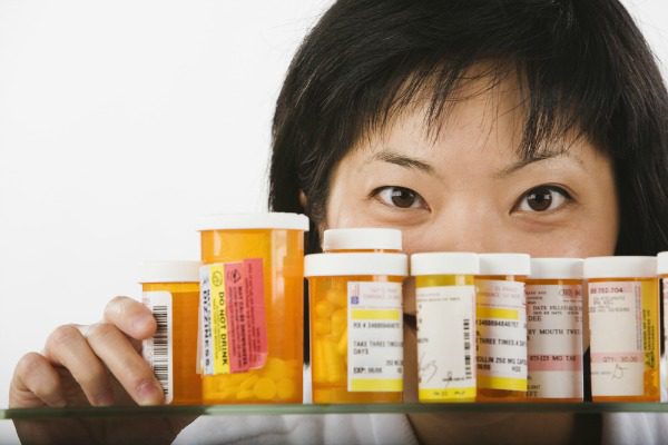 Woman looking in medicine cabinet