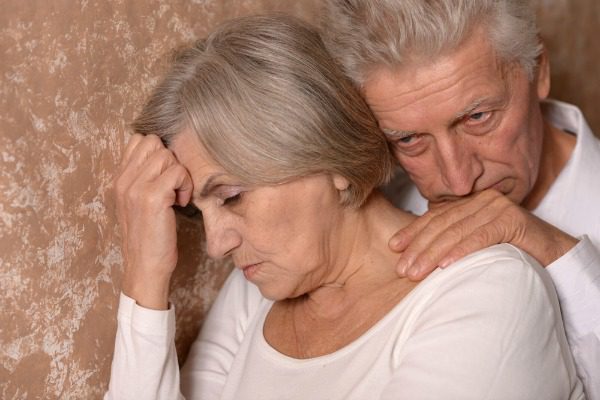 Worried elderly couple