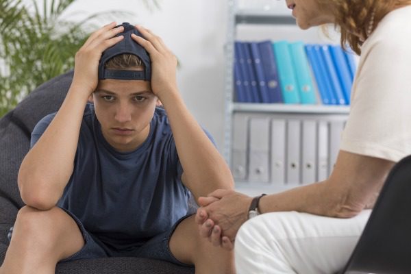 Young addict with therapist