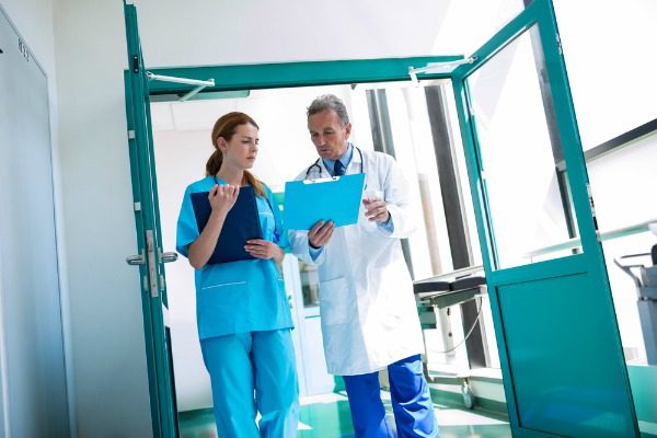 Doctor and nursing reviewing records