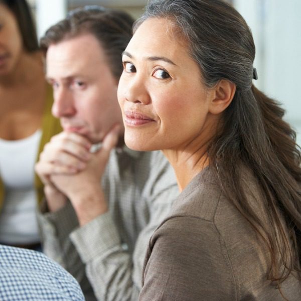 Happy woman in therapy group