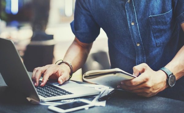 Man doing online research on laptop