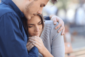 a man hugs his girlfriend after she returns home from rehab