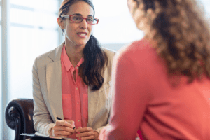 female therapist explaining to female patient the benefits of personalized addiction treatment
