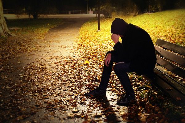 Young homeless man in park