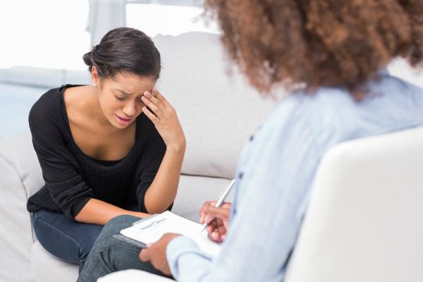 Troubled woman with counselor