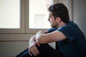 Contemplative man looking out of window