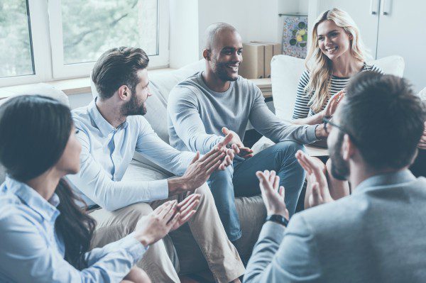 Counseling participants congratuling group member