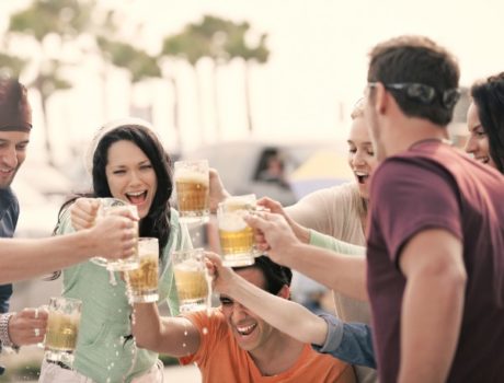 Friends toasting beer mugs
