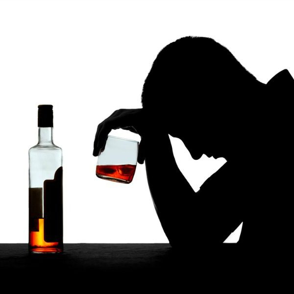 Alcoholic man sitting alone