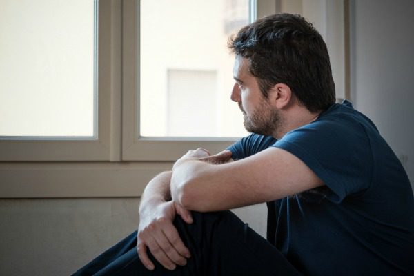 Man looking out window