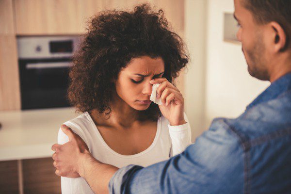 Husband consoling distressed spouse