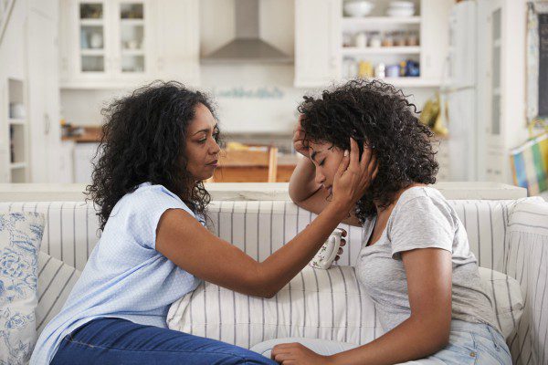Mom comforting teen daughter