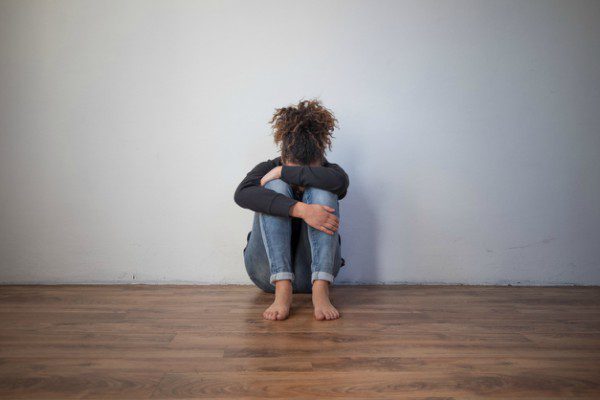 Sad black girl on floor