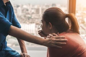 a woman thinks about entering a 12-step treatment program