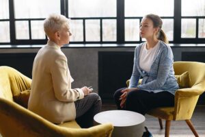 two people discuss addiction treatment programs