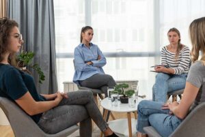 people work together in an anger management and addiction treatment program