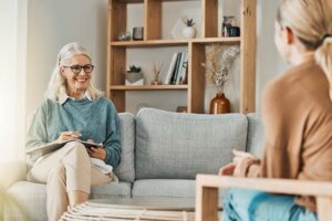 a woman helps someone work through depression and addiction treatment