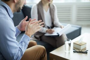 a woman discusses rehab insurance coverage with a potential client