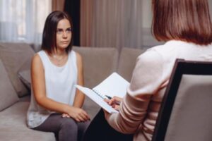 a woman learns about a painkiller addiction treatment program