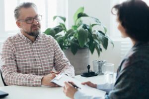 two people discuss paying for addiction treatment
