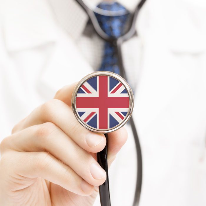 Doctor holding a stethoscope with UK flag
