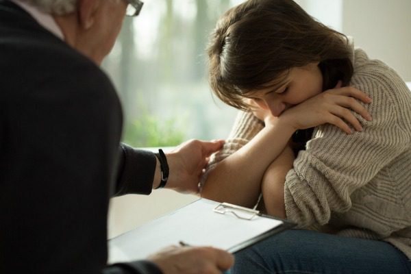 Troubled woman with counselor