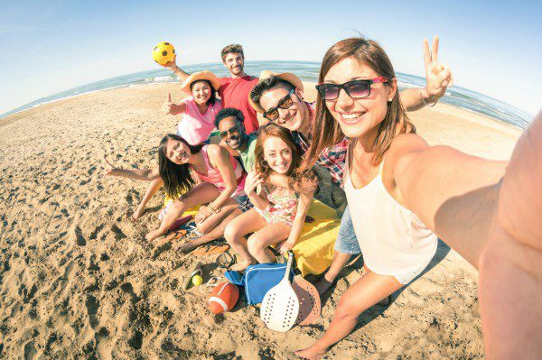 Friends on beach taking selfie