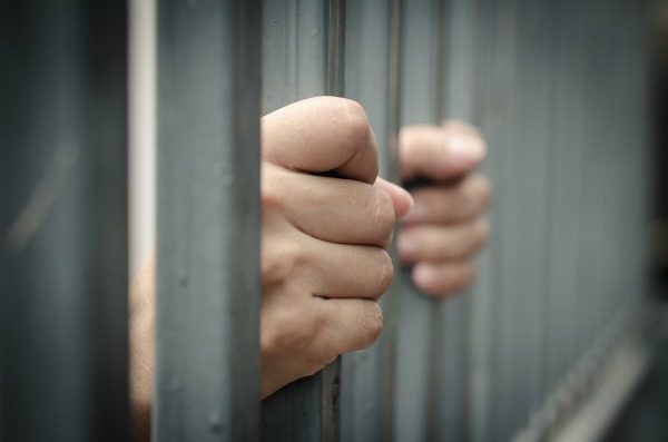 Hands on jail bars