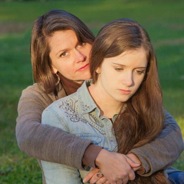 Mother holding addict daughter