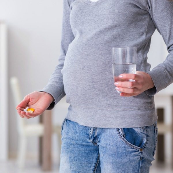 Pregnant woman taking pills