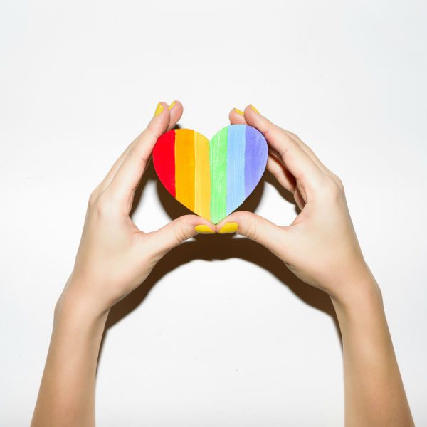 Rainbow heart in hands
