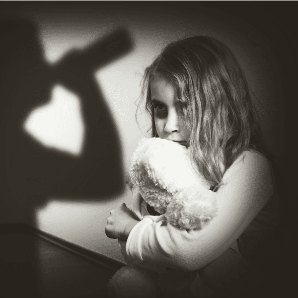 Scared girl in shadow of alcoholic father