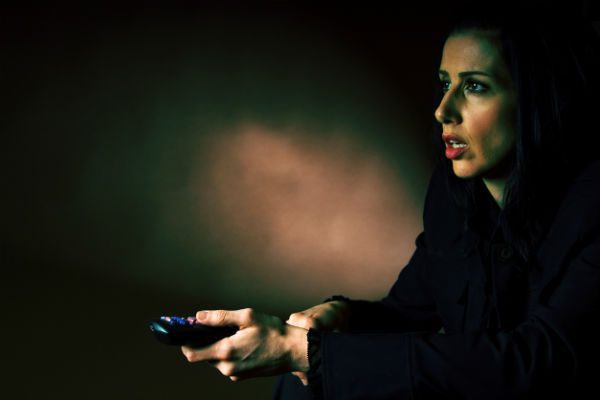 Woman watching disturbing TV