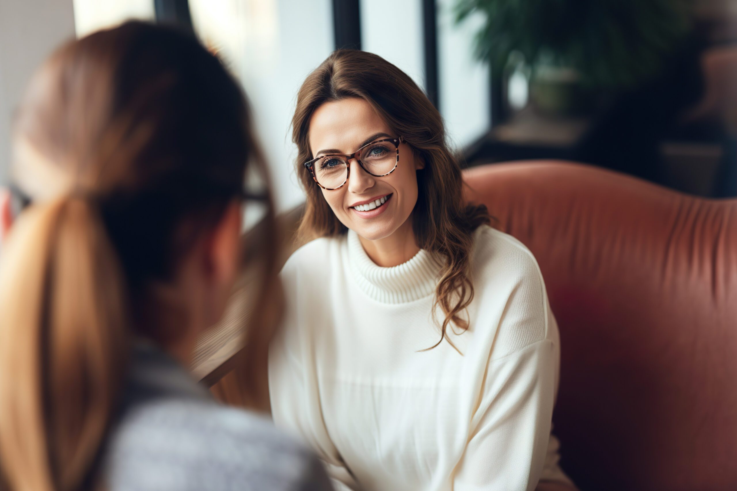 a woman with glasses sits on a couch and asks the person across from her what is a functional alcoholic