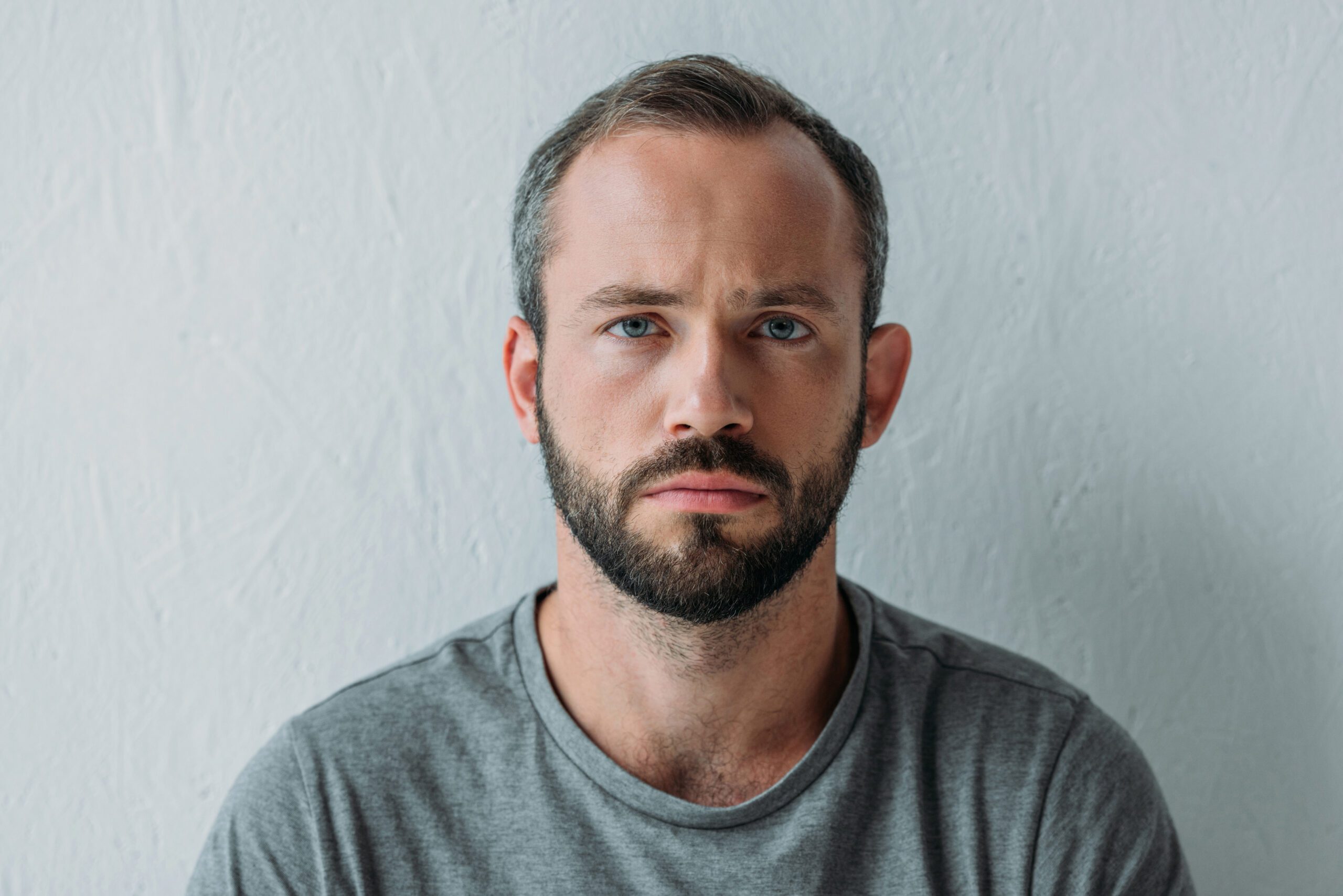 Man with beard looks forward and wonders what is an addictive personality