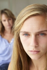 Unhappy teenage girl with mother